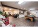 Basement area with game table, comfortable seating, and stairway to upper level at 8220 Traders Hollow Ct, Indianapolis, IN 46278