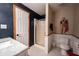 Bathroom featuring a glass enclosed shower, white wainscoting, and updated fixtures at 8220 Traders Hollow Ct, Indianapolis, IN 46278