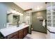 Well-appointed bathroom with a wooden vanity, a glass block accent wall, and modern lighting at 8220 Traders Hollow Ct, Indianapolis, IN 46278
