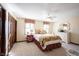 Bedroom featuring neutral walls, carpeted floors, ceiling fan, two bright windows, and furniture at 8220 Traders Hollow Ct, Indianapolis, IN 46278
