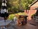 Outdoor deck with lush landscaping and brick features at 8220 Traders Hollow Ct, Indianapolis, IN 46278