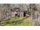 Charming brick home with black shutters, a manicured lawn, and surrounded by trees at 8220 Traders Hollow Ct, Indianapolis, IN 46278