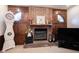 Close up of a brick fireplace with mantel, wood paneling, and decorative accents at 8220 Traders Hollow Ct, Indianapolis, IN 46278