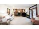 Charming living room with brick fireplace, wood paneling, and ample seating at 8220 Traders Hollow Ct, Indianapolis, IN 46278