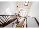 Bright, airy foyer with hardwood floors, chandelier, and staircase leading to upper level at 8220 Traders Hollow Ct, Indianapolis, IN 46278