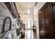 Charming foyer featuring hardwood floors, chandelier, and staircase with rustic wood accent wall at 8220 Traders Hollow Ct, Indianapolis, IN 46278