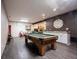 Spacious game room featuring a pool table, accent wall, recessed lights, and access to more entertaining space at 8220 Traders Hollow Ct, Indianapolis, IN 46278
