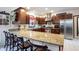 Kitchen with granite countertops, stainless steel appliances, eat-in breakfast bar, and ample storage at 8220 Traders Hollow Ct, Indianapolis, IN 46278