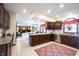 Open kitchen with granite countertops and stainless steel appliances that seamlessly flows into the adjacent living room at 8220 Traders Hollow Ct, Indianapolis, IN 46278