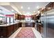 Spacious kitchen features a large island, stainless steel appliances, tile flooring, and ample cabinet space at 8220 Traders Hollow Ct, Indianapolis, IN 46278