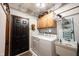 Bright laundry room with a washer, dryer, utility sink, and plenty of storage space at 8220 Traders Hollow Ct, Indianapolis, IN 46278