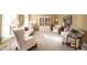 Elegant living room with neutral carpet, white sofas, and built-in display cabinet at 8220 Traders Hollow Ct, Indianapolis, IN 46278