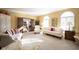 Spacious living room with neutral carpet, white sofas, and arched windows at 8220 Traders Hollow Ct, Indianapolis, IN 46278