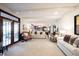 Expansive living room with fireplace, open access to the kitchen, and french doors at 8220 Traders Hollow Ct, Indianapolis, IN 46278