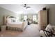 Serene main bedroom with a ceiling fan, offers a peaceful retreat with exercise equipment at 8220 Traders Hollow Ct, Indianapolis, IN 46278