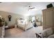 Spacious main bedroom features a comfortable bed, a ceiling fan, and ample natural light at 8220 Traders Hollow Ct, Indianapolis, IN 46278