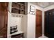 Charming mudroom boasts built-in storage, coat hooks, and a cozy bench with a stylish throw pillow at 8220 Traders Hollow Ct, Indianapolis, IN 46278