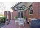 Outdoor patio with umbrella and wrought iron furniture next to brick wall at 8220 Traders Hollow Ct, Indianapolis, IN 46278