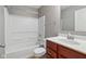 Bright bathroom with cherrywood vanity, tub and shower combo, and tiled floors at 8233 Katrina Way, Fishers, IN 46038