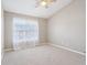 Cozy carpeted bedroom showcasing a ceiling fan and large window dressed with sheers at 8233 Katrina Way, Fishers, IN 46038