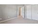 Carpeted bedroom features large closet, open door to hallway, and neutral color palette at 8233 Katrina Way, Fishers, IN 46038