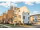 Attractive townhome with a combination of light beige siding, brick accents, and well-maintained landscaping at 8233 Katrina Way, Fishers, IN 46038