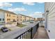 Balcony with railings overlooking a street lined with similar townhomes and parked cars at 8233 Katrina Way, Fishers, IN 46038