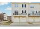Townhome garage and balcony view, complemented by a well-kept lawn at 8233 Katrina Way, Fishers, IN 46038