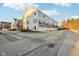 Townhome exteriors featuring individual garages, charming balconies, and meticulous landscaping at 8233 Katrina Way, Fishers, IN 46038