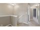 Stairway landing with beige walls leading to a hallway at 8233 Katrina Way, Fishers, IN 46038