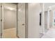 Hallway leads to rooms separated by a door with white door frames and columns for support at 8233 Katrina Way, Fishers, IN 46038