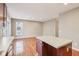Kitchen with hardwood flooring and large island, with view of large living space at 8233 Katrina Way, Fishers, IN 46038