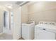 Well-equipped laundry area with a washing machine, dryer, and shelving for convenient storage at 8233 Katrina Way, Fishers, IN 46038