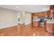 Open concept living room flowing into the kitchen with hardwood floors and natural light at 8233 Katrina Way, Fishers, IN 46038