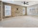 Living room featuring a modern accent wall, large windows, and plush carpeting at 8233 Katrina Way, Fishers, IN 46038