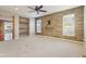 Spacious living room with built-in shelving, carpet, and a decorative accent wall at 8233 Katrina Way, Fishers, IN 46038