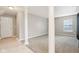 Spacious living room with gray walls, carpeting, columns and large window at 8233 Katrina Way, Fishers, IN 46038