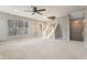 Bright living room with staircase, large window, and ceiling fan at 8233 Katrina Way, Fishers, IN 46038