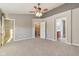 Large primary bedroom with ceiling fan and two doorways and ample floor space at 8233 Katrina Way, Fishers, IN 46038