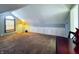 Spacious attic area provides ample storage space with wall-to-wall cabinets and natural light from a window at 850 N Butler Ave, Indianapolis, IN 46219