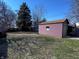 Large backyard featuring a detached garage with a brown roof, offering ample space for outdoor activities at 850 N Butler Ave, Indianapolis, IN 46219