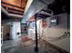 Unfinished basement area with laundry and utilities featuring an exposed ceiling at 850 N Butler Ave, Indianapolis, IN 46219
