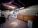 Unfinished basement with exposed ceiling features ample room for storage and utilities at 850 N Butler Ave, Indianapolis, IN 46219