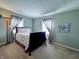 Cozy bedroom features a comfortable bed, soft carpeting, and neutral wall colors with a Tiffany-style lamp at 850 N Butler Ave, Indianapolis, IN 46219