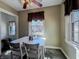 Bright dining area with a classic table set, window views and vintage charm at 850 N Butler Ave, Indianapolis, IN 46219