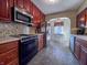 Well-equipped kitchen featuring stainless steel appliances, dark wood cabinets and tile backsplash at 850 N Butler Ave, Indianapolis, IN 46219