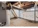 Spacious unfinished basement with concrete flooring and access to upper levels via wooden stairs at 866 W 29Th St, Indianapolis, IN 46208