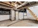 Unfinished basement with painted brick walls, wood stairs, and exposed beams at 866 W 29Th St, Indianapolis, IN 46208