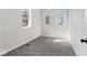 This bedroom features neutral walls, plush carpeting, and ample natural light from two windows at 866 W 29Th St, Indianapolis, IN 46208