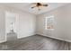 Neutrally painted bedroom showcasing gray floors, a ceiling fan, and a window with a view at 866 W 29Th St, Indianapolis, IN 46208